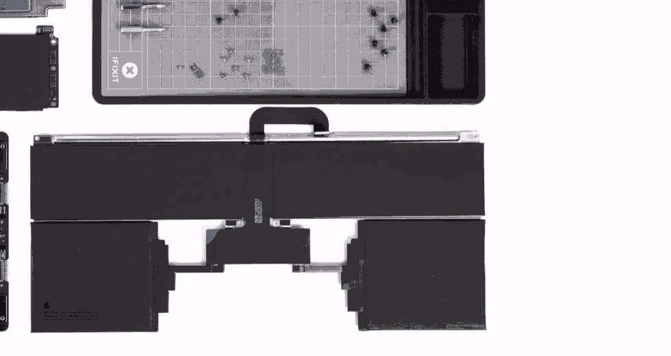 Close view of the segmented black battery removed from an M4 MacBook Air